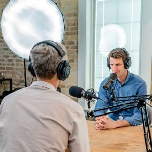 Two people doing an interview for a podcast
